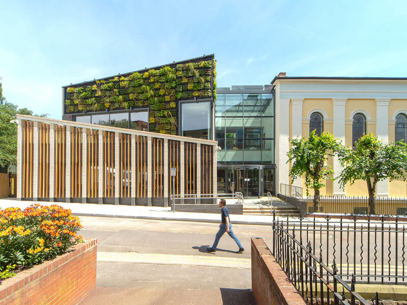 Man walking in front of a university building